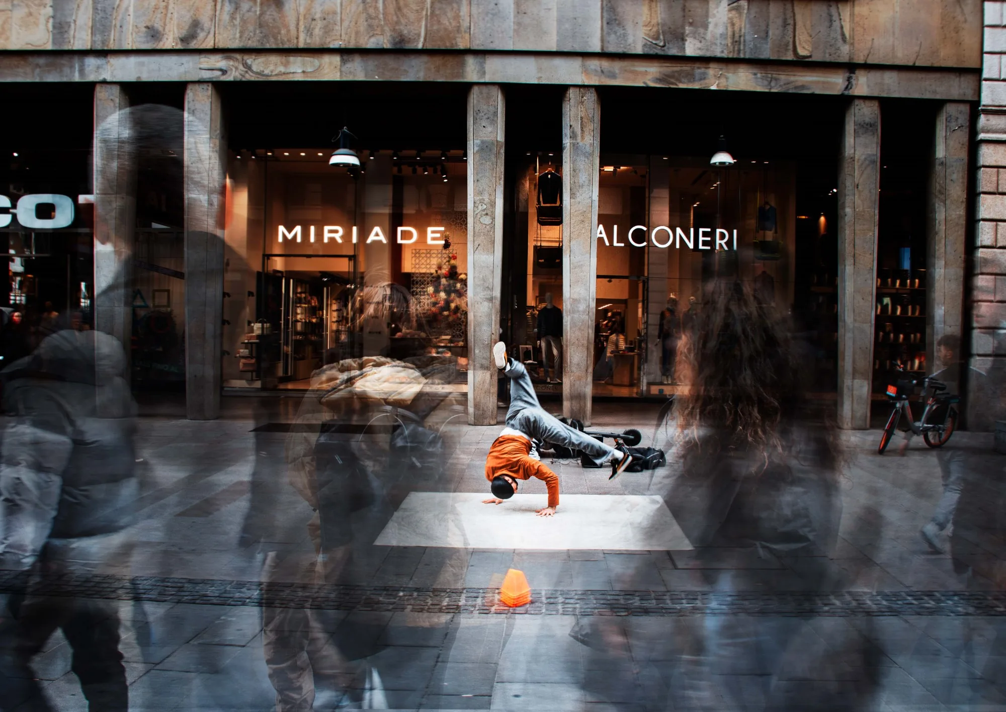 A street performer held still against a moving city
