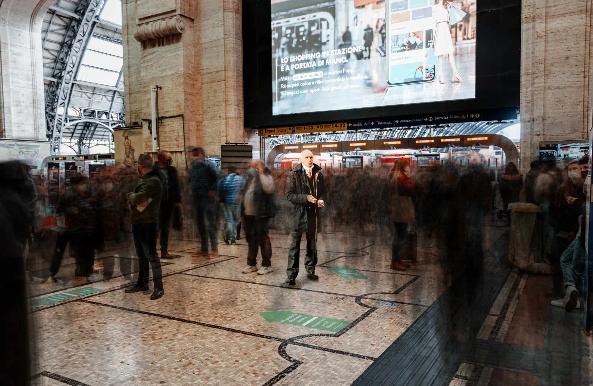 Travelers moving through Milano station